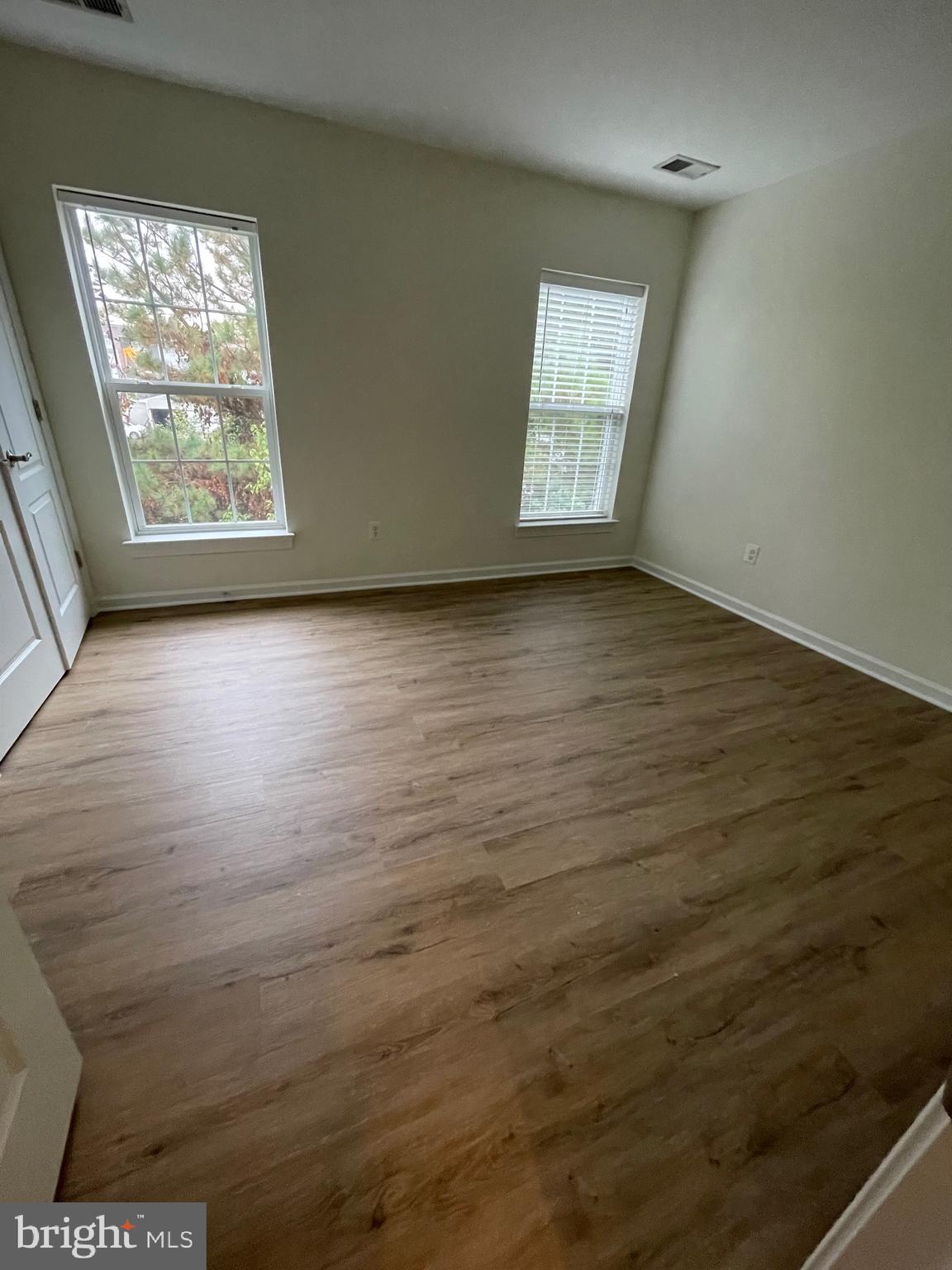 7454 Riding Meadow Way Manassas, VA 20111 - Photo 11 of 21 an empty room with wooden floor and windows