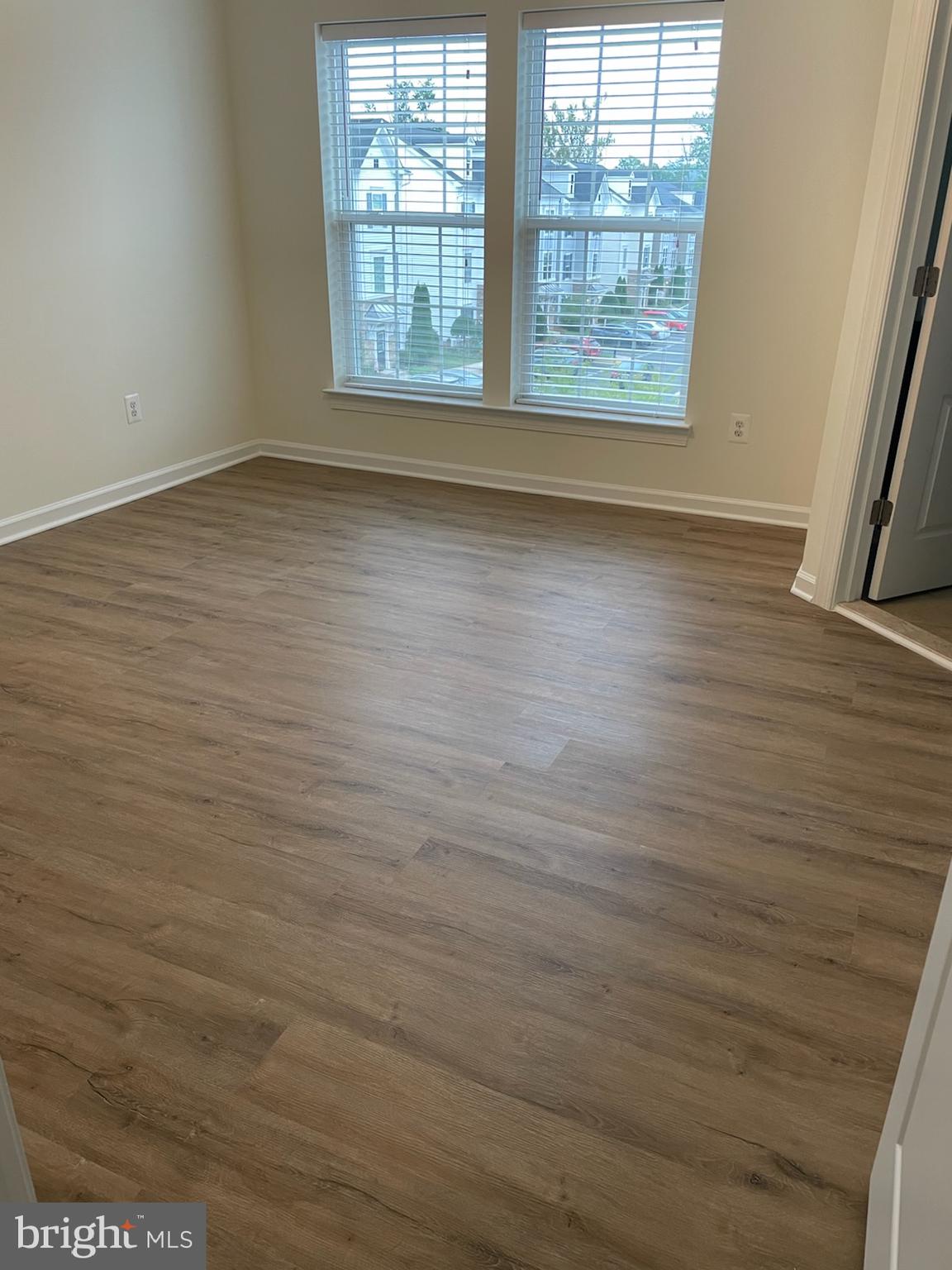 7454 Riding Meadow Way Manassas, VA 20111 - Photo 14 of 21 an empty room with wooden floor and windows