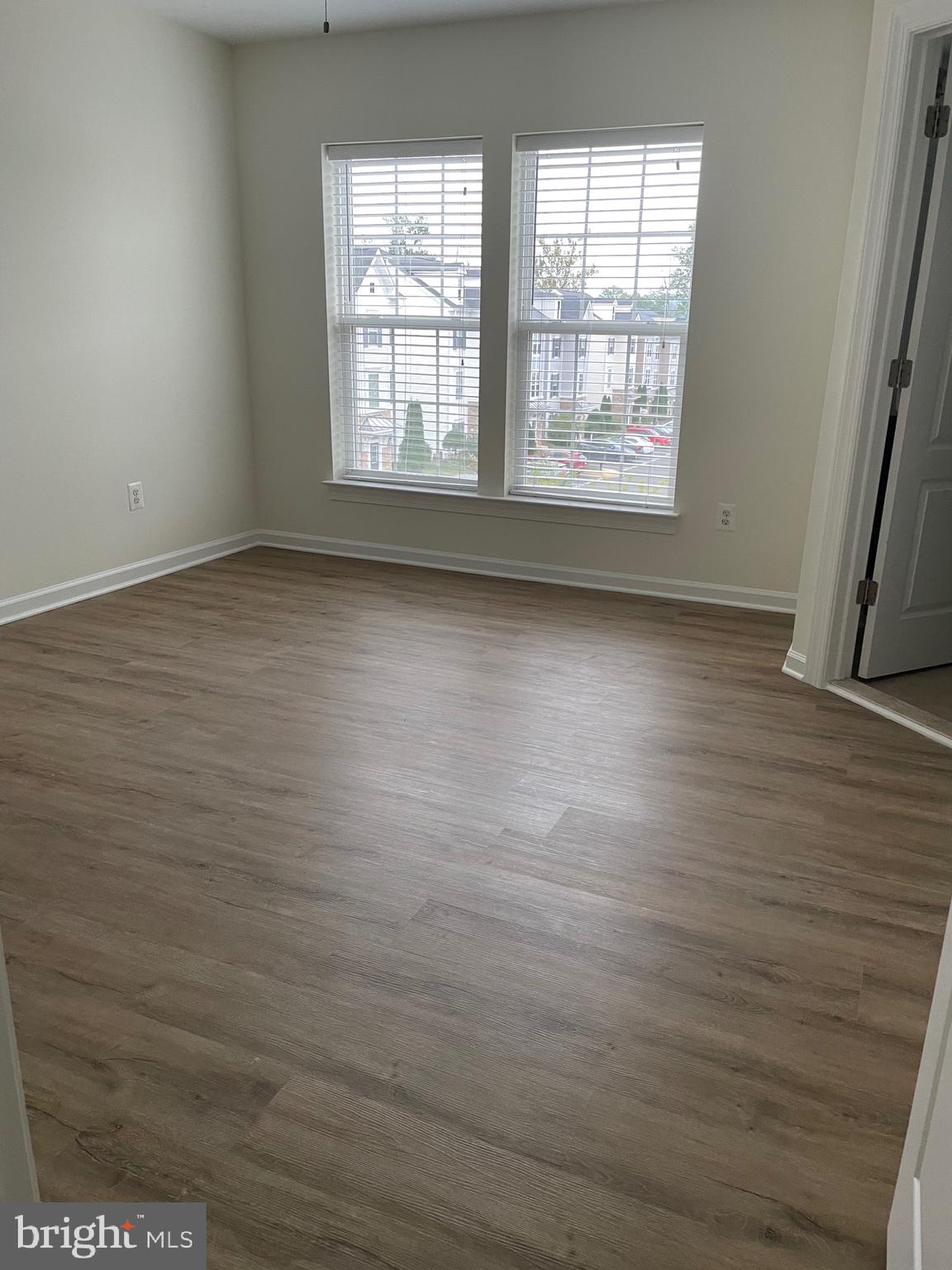 7454 Riding Meadow Way Manassas, VA 20111 - Photo 16 of 21 an empty room with wooden floor and windows