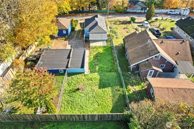 an aerial view of a house with a yard and trees