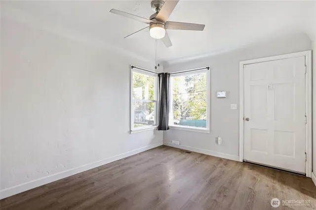 wooden floor in an empty room with a window