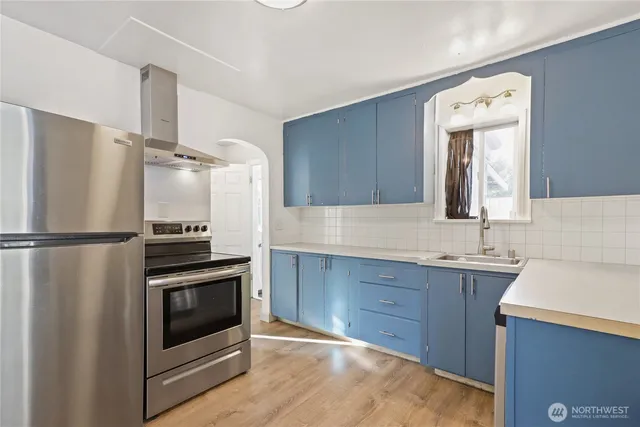 a kitchen with stainless steel appliances a refrigerator and a sink