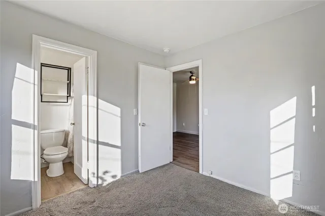 a view of a bathroom with a toilet and a shower