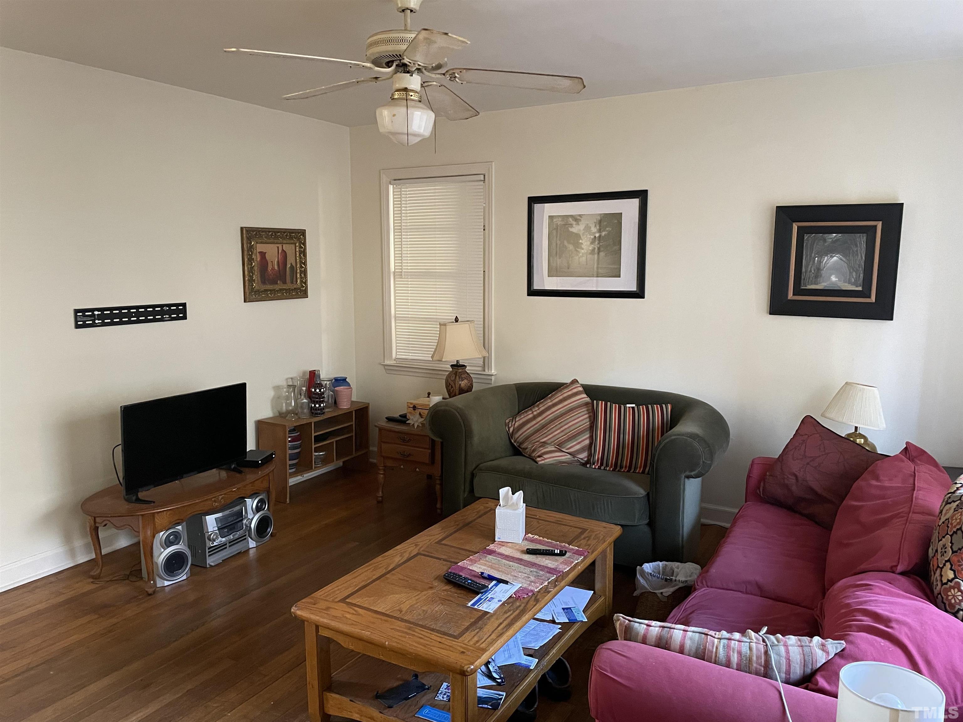 1518 Ashburton Road Raleigh, NC 27606 - Photo 2 of 10 a living room with furniture a flat screen tv and a window