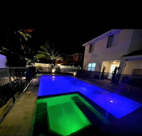 a room with pool table and chairs