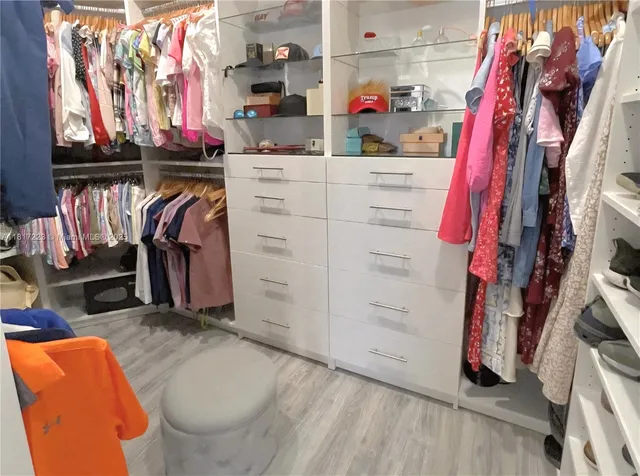 a bathroom with a double vanity sink mirror and bathtub