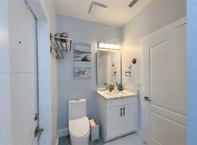 a bathroom with a double vanity sink toilet mirror and shower