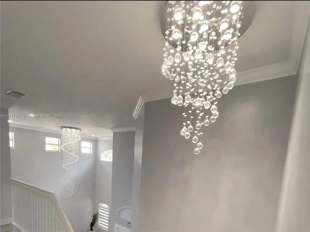 a view of hallway with stairs and wooden floor