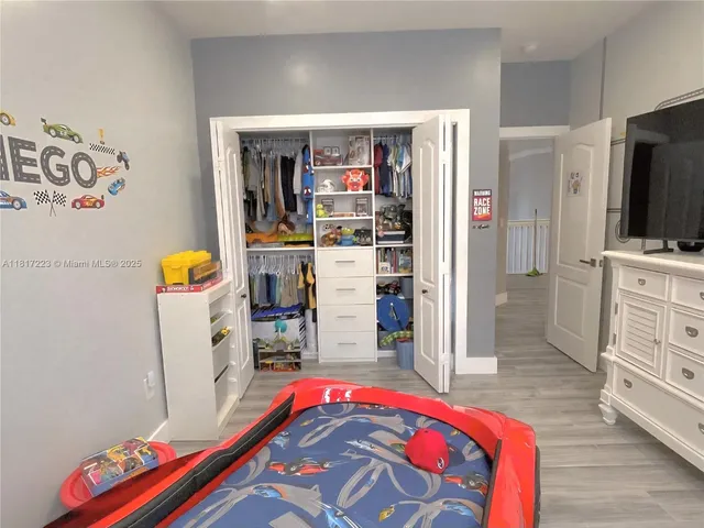 a view of a kitchen with fridge and wooden floor