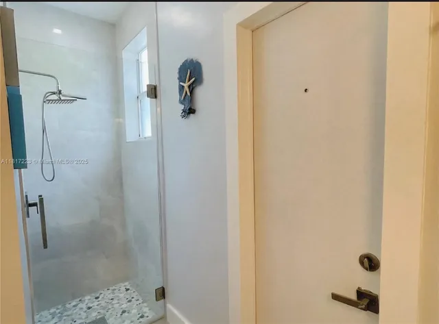 a room with wooden floor pool table and chairs