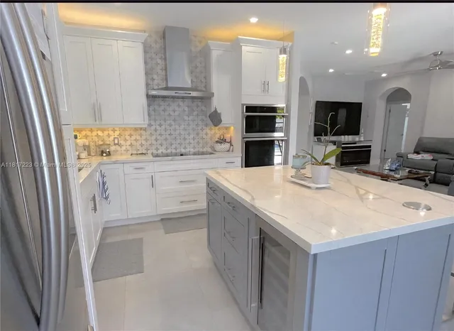 a kitchen with stainless steel appliances granite countertop a sink and a stove
