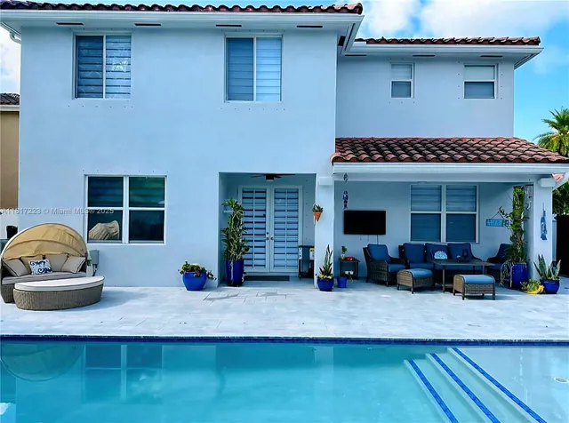 a view of swimming pool with a sitting area and slide