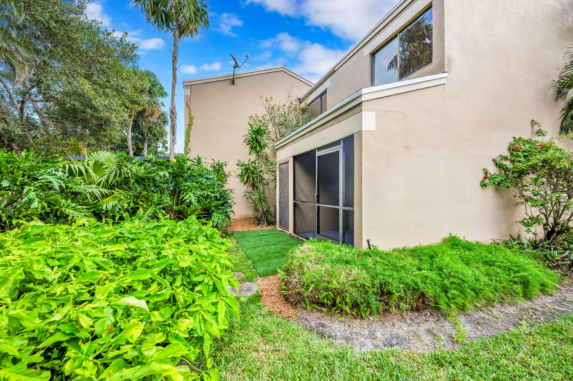 1169 Northwest 13th Street, Unit 1 Boca Raton, FL 33486 - Photo 14 of 20 a view of a back yard of the house