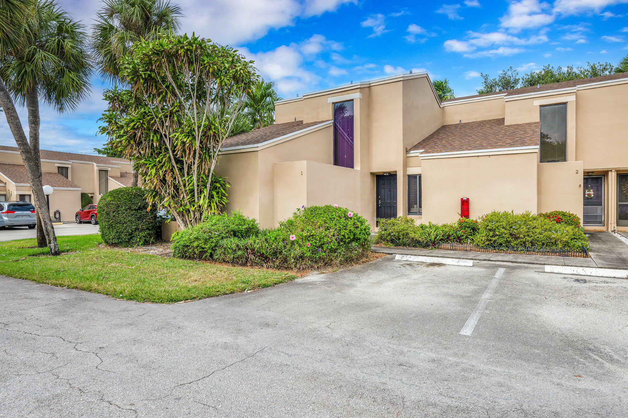 1169 Northwest 13th Street, Unit 1 Boca Raton, FL 33486 - Photo 16 of 20 a front view of a house with a yard and a garage