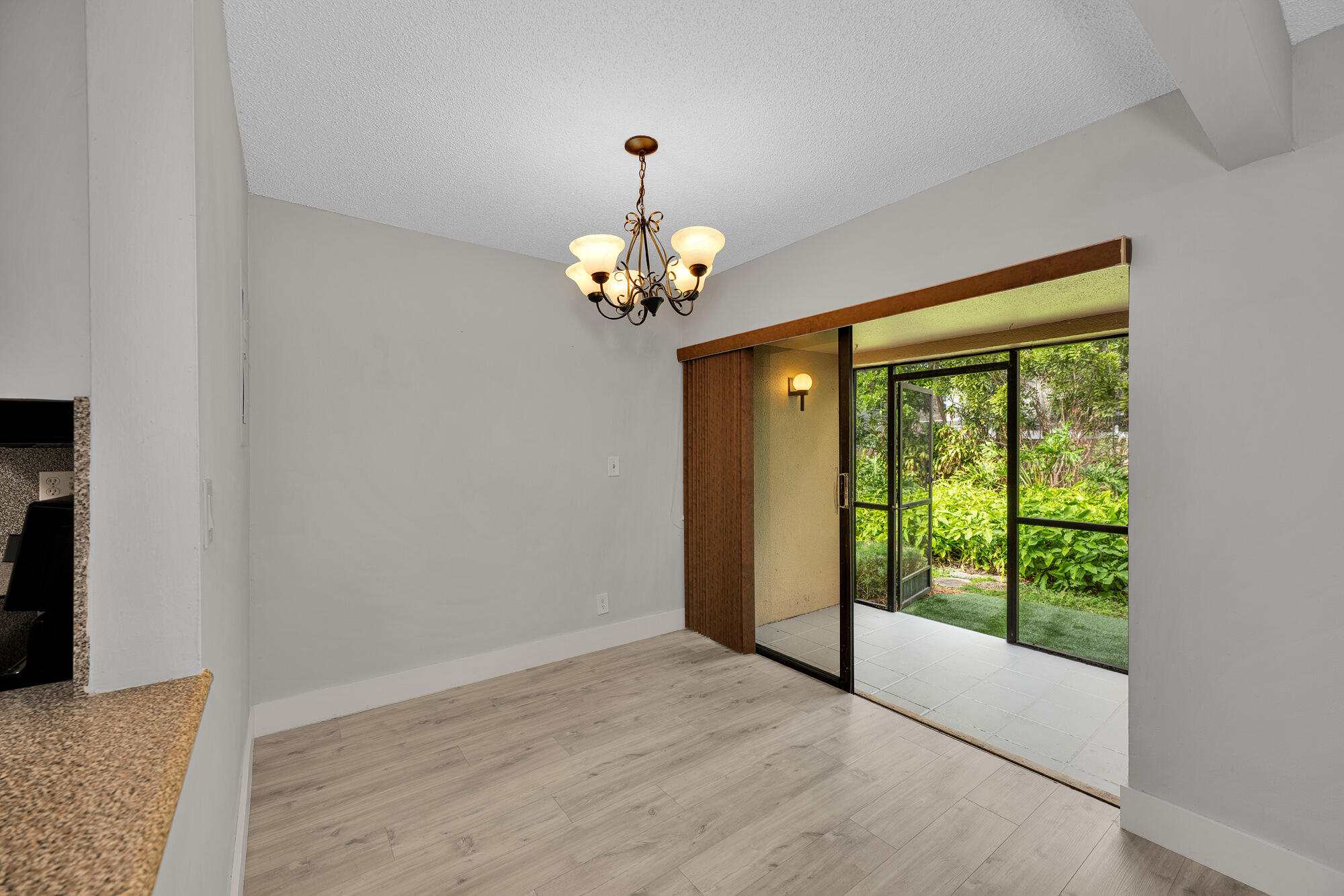 1169 Northwest 13th Street, Unit 1 Boca Raton, FL 33486 - Photo 6 of 20 a view of an empty room with a window