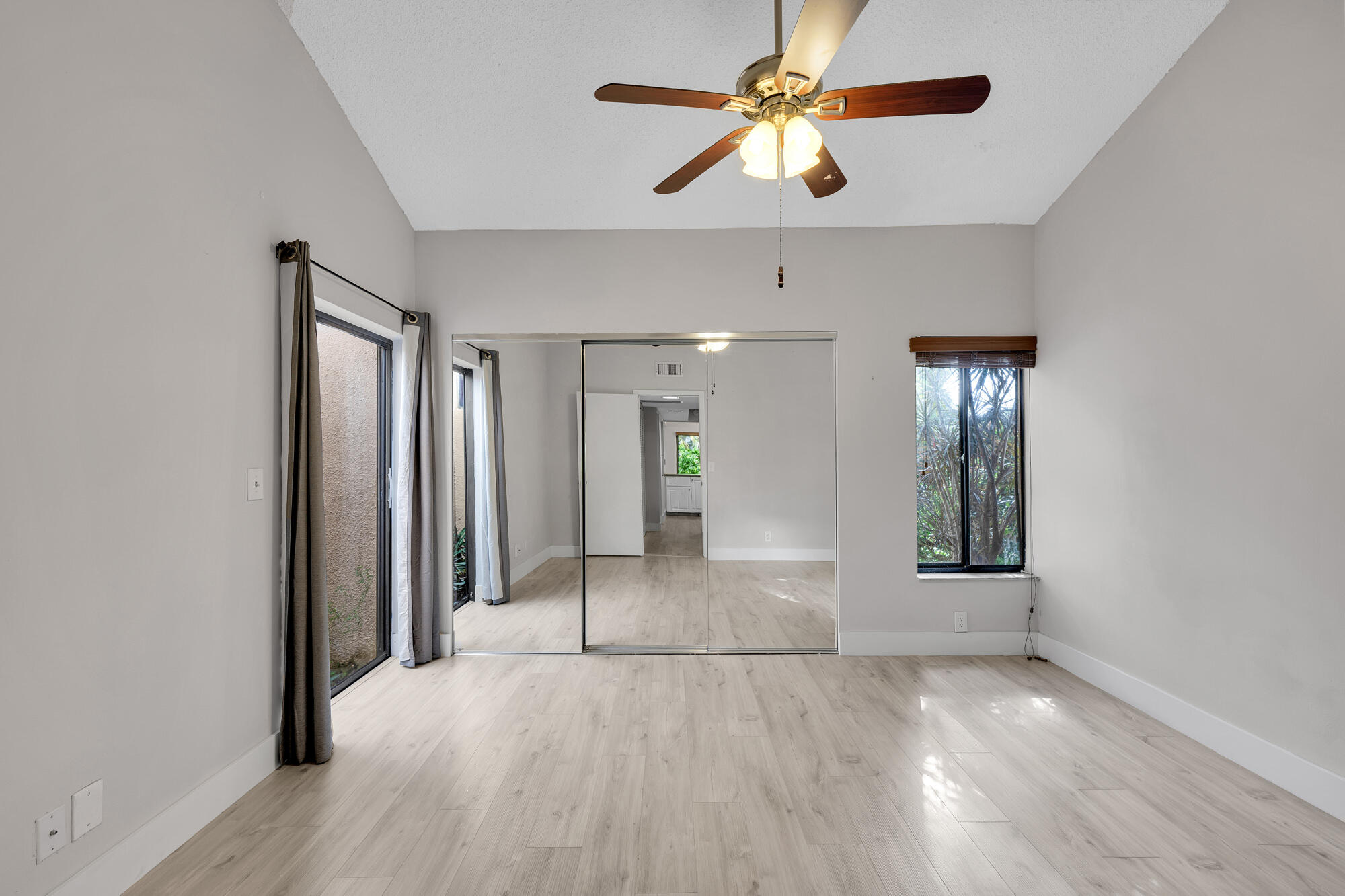 1169 Northwest 13th Street, Unit 1 Boca Raton, FL 33486 - Photo 8 of 20 wooden floor in an empty room with a window