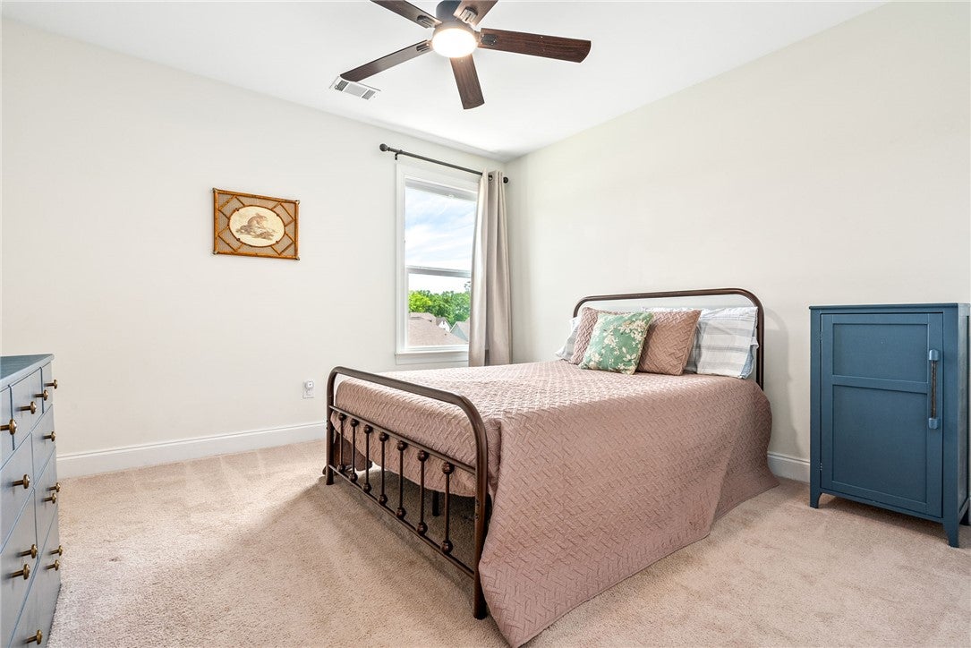 2324 Rutland Road Auburn, AL 36832 - Photo 17 of 22 This cozy bedroom offers a tranquil retreat with soft carpet and a window inviting natural light.