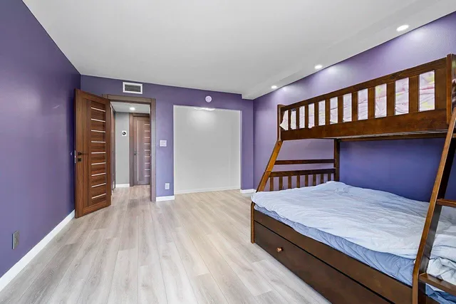 a bedroom with a bed and a bookshelf