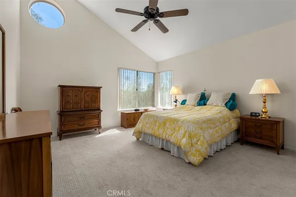 a spacious bedroom with a bed and dresser