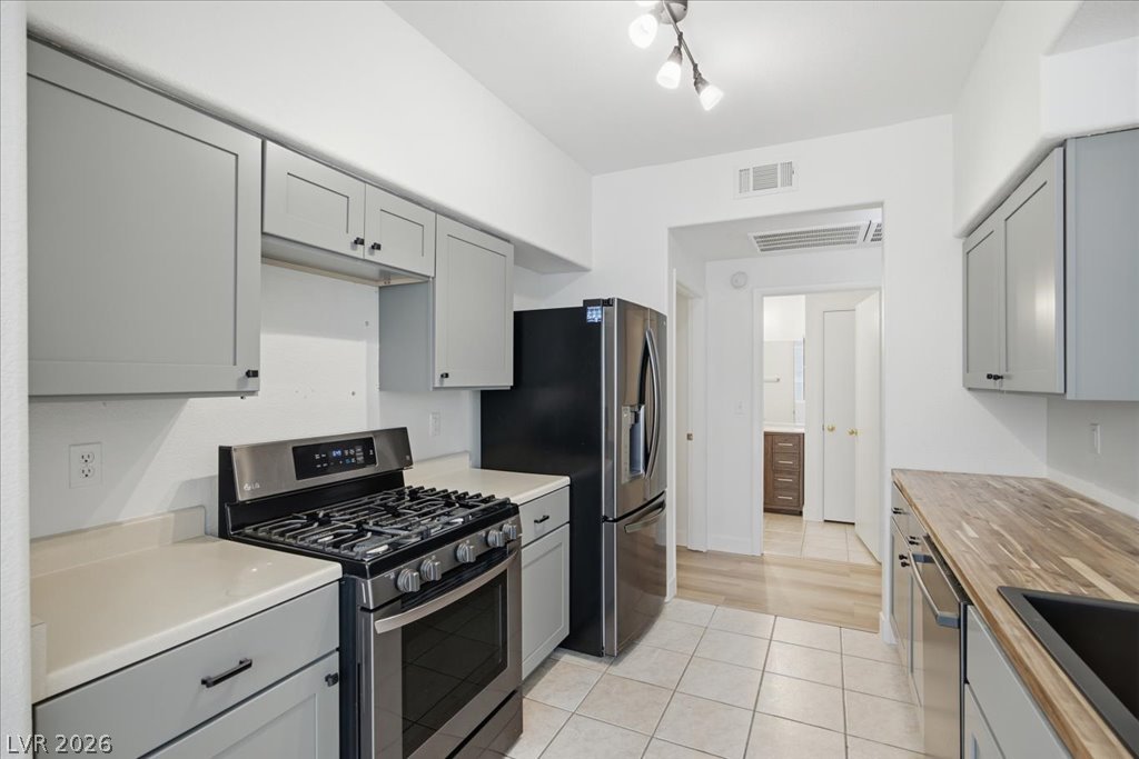 9050 West Warm Springs Road, Unit 1033 Las Vegas, NV 89148 - Photo 7 of 26 Culinary aspirations find a home in this compact kitchen, featuring a gas range and stainless steel appliances.