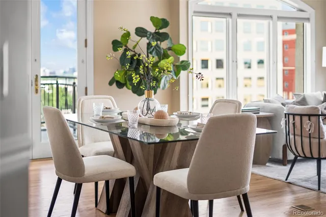 a dining room with furniture potted plants and wooden floor