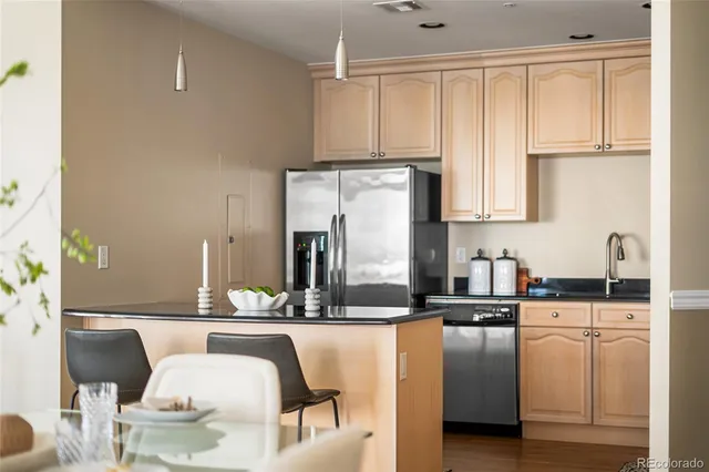 a kitchen with kitchen island granite countertop a sink and white cabinets