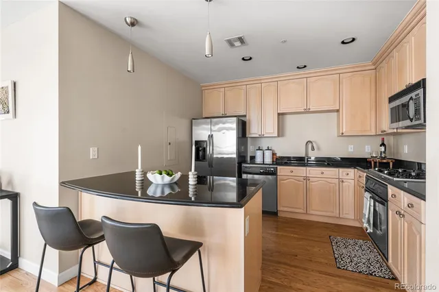 a kitchen with granite countertop a sink cabinets and refrigerator