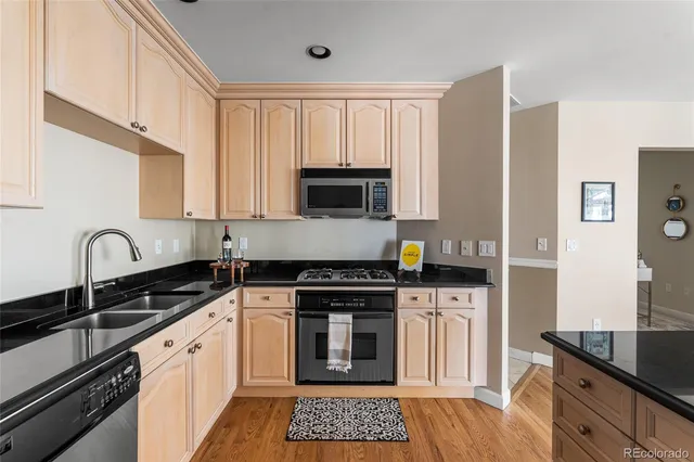 a kitchen with granite countertop a stove sink and cabinets
