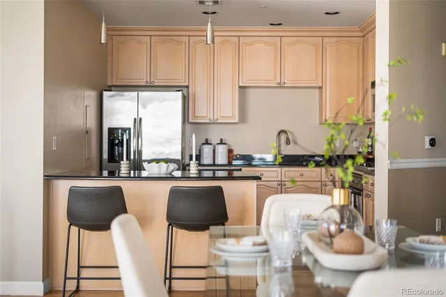 a kitchen with appliances cabinets and chair