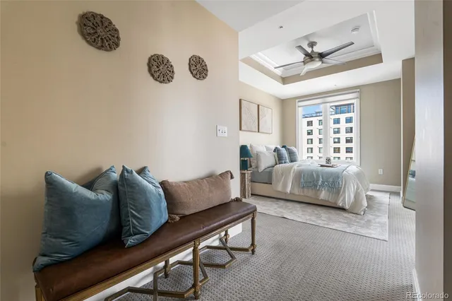 a bedroom with a bed couch and window