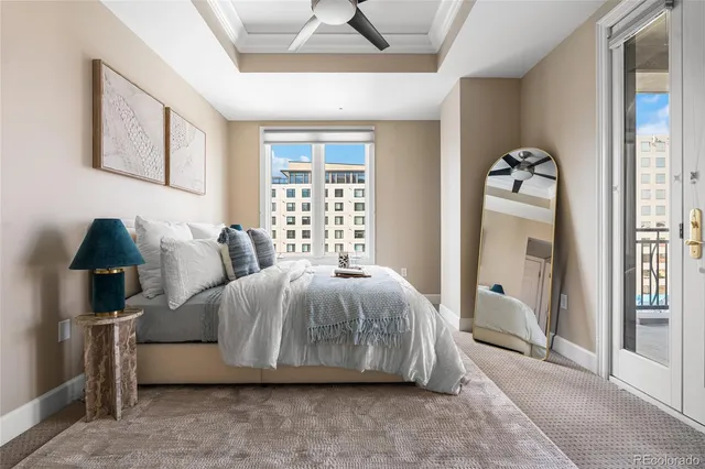 a spacious bedroom with a bed and a lamp