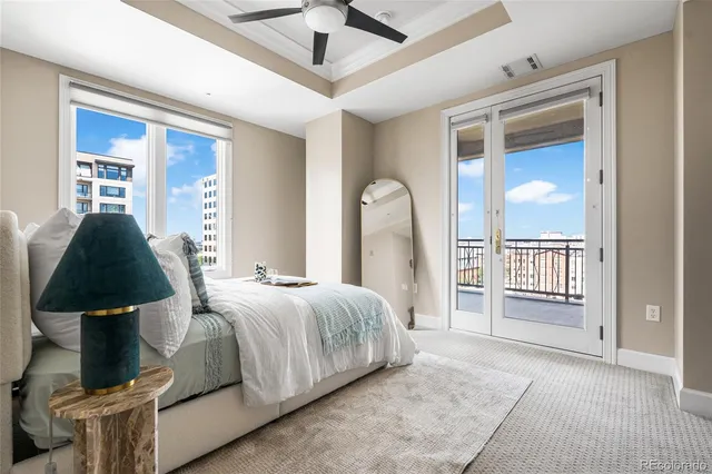a bedroom with a large bed and a chandelier