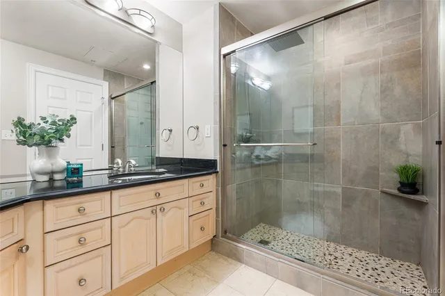 a bathroom with a shower sink and mirror