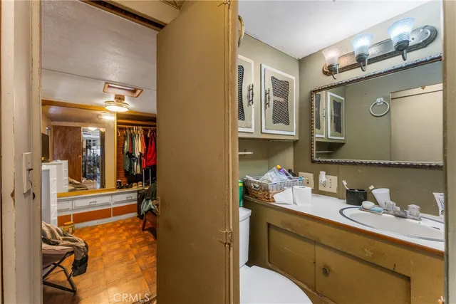 a bathroom with a sink vanity and mirror