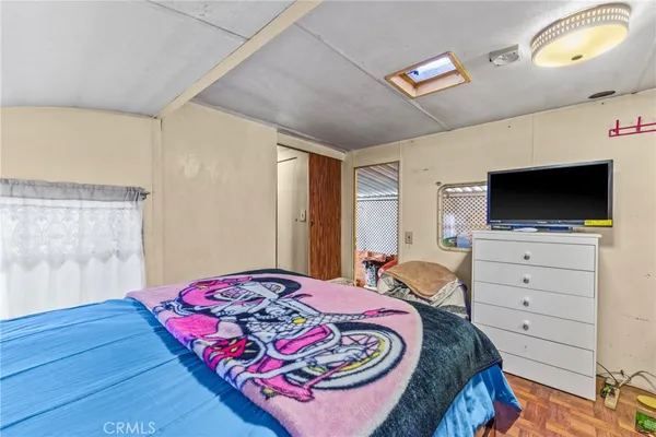 a bedroom with a bed and flat screen tv