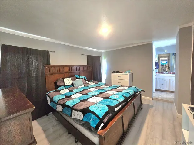 a large bed sitting in a bedroom and a table