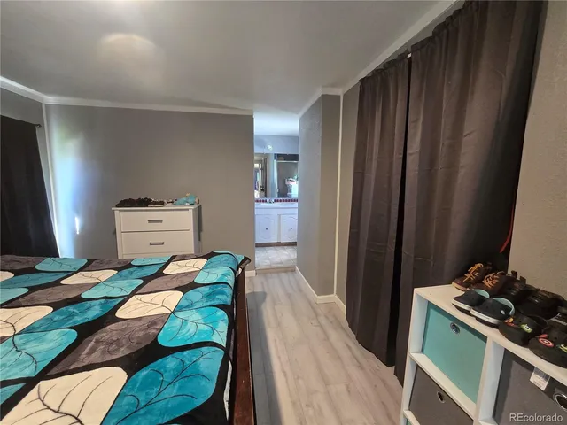 a bed sitting in a bedroom next to a window