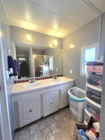 a bathroom with a granite countertop sink and mirror