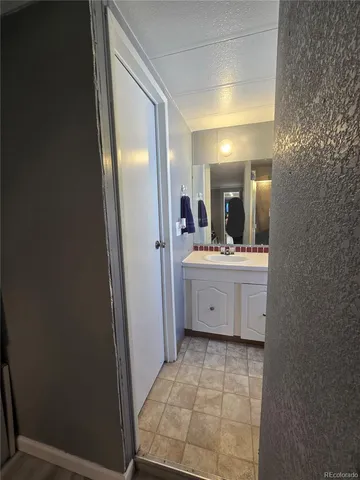 a bathroom with a sink a mirror and a vanity