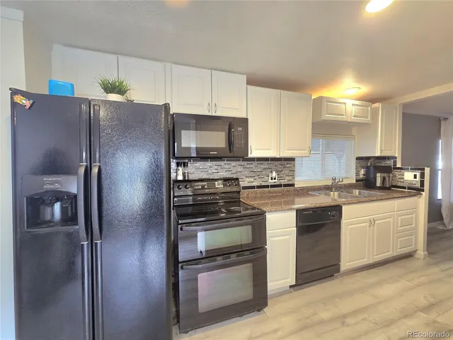 a kitchen with a refrigerator stove and sink