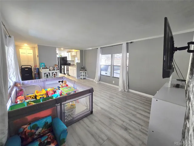 a living room with furniture pool table and a flat screen tv