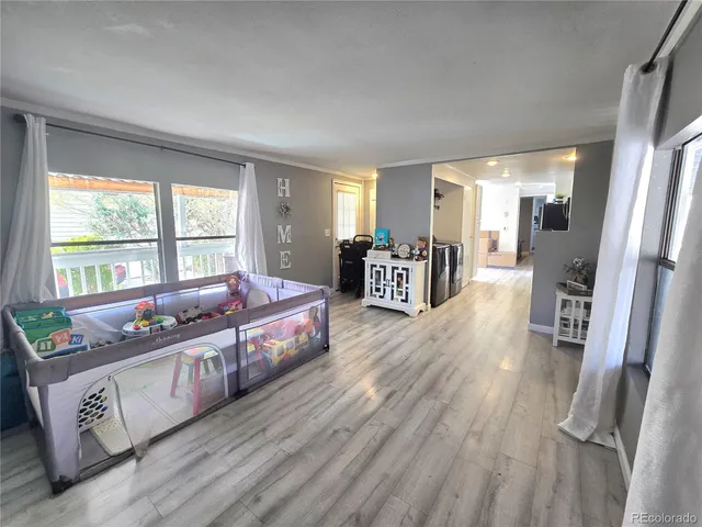 a spacious bedroom with a bed and wooden floor