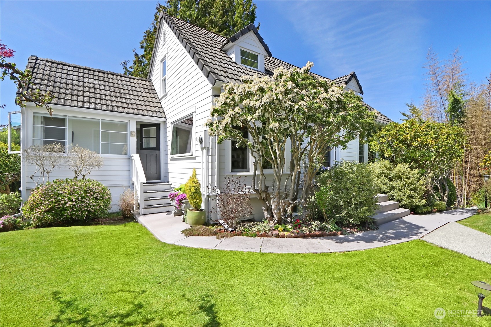 1055 Daley Street Edmonds, WA 98020 - Photo 1 of 28 a front view of a house with a garden