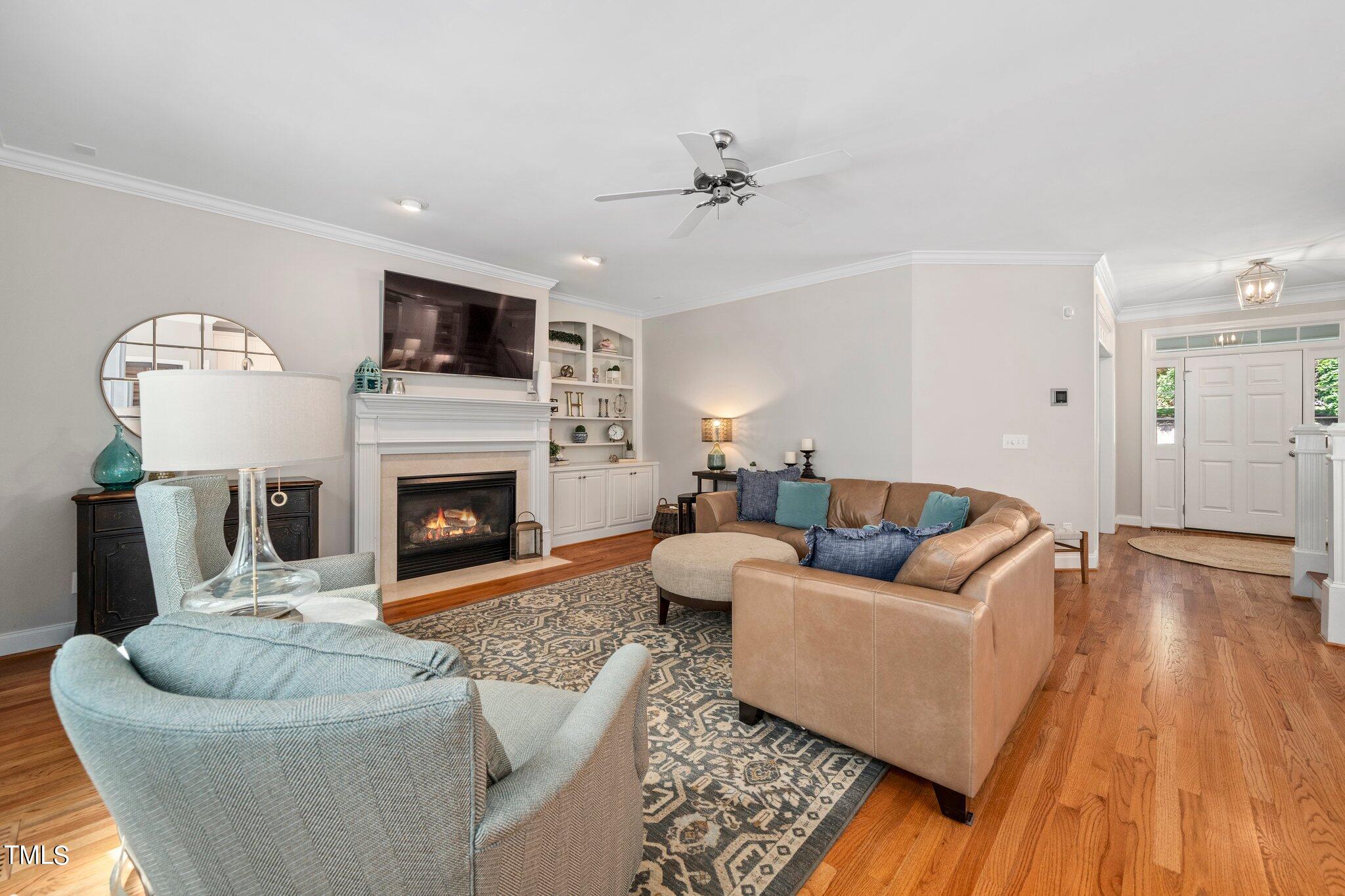 109 Chilcott Lane Apex, NC 27502 - Photo 11 of 34 a living room with furniture and a fireplace