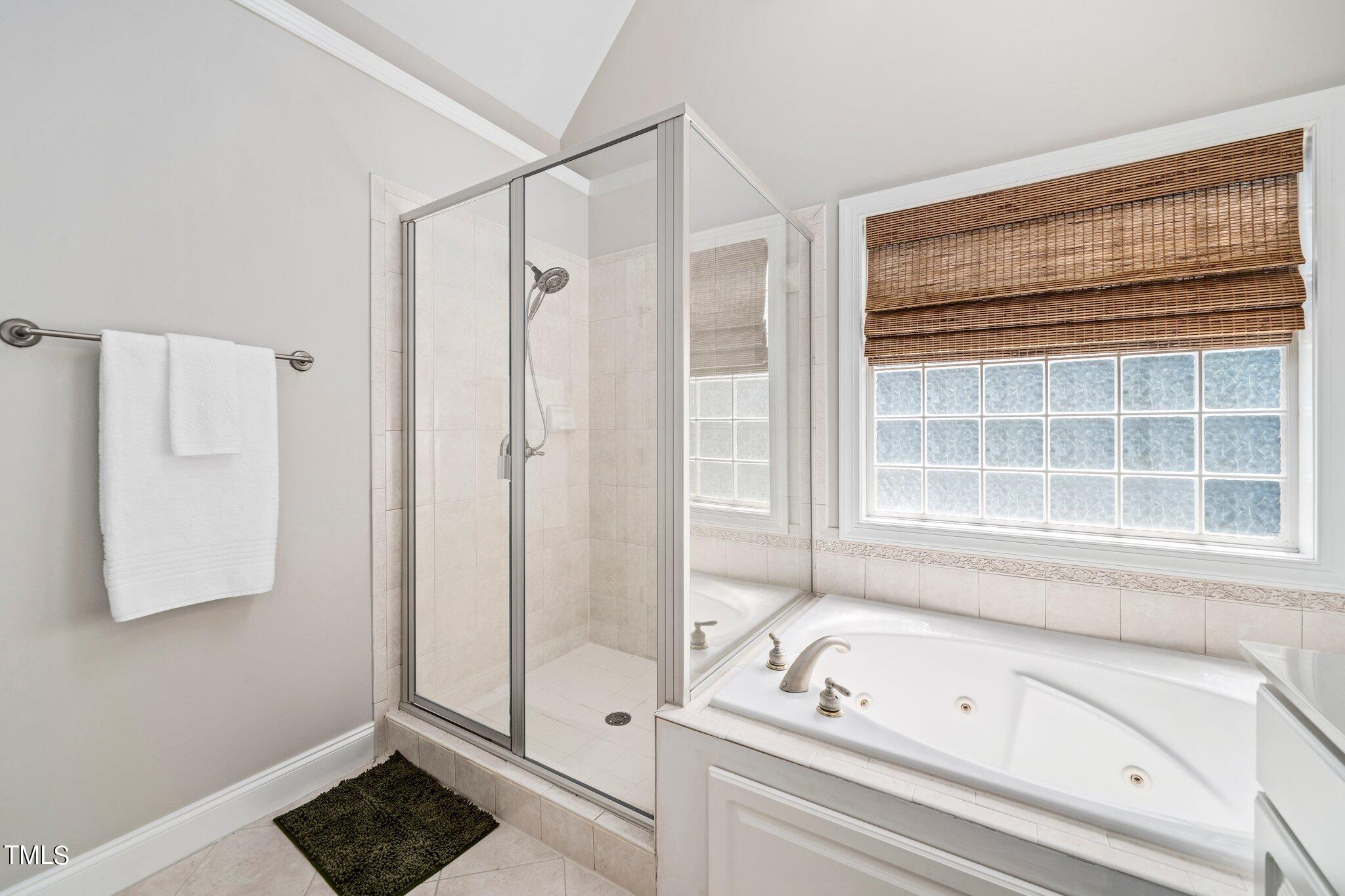 109 Chilcott Lane Apex, NC 27502 - Photo 21 of 34 a bathroom with a bathtub and a shower