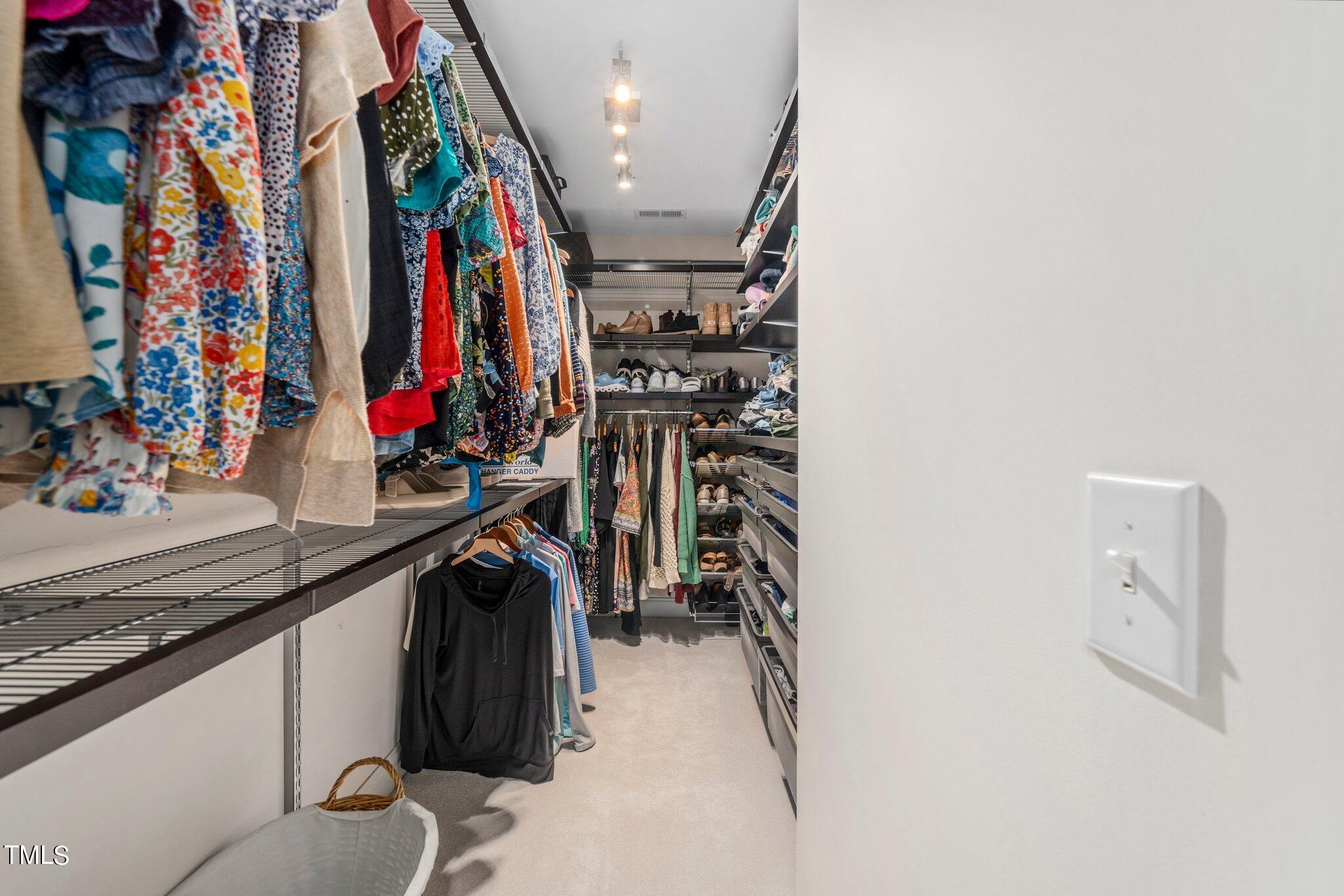 109 Chilcott Lane Apex, NC 27502 - Photo 22 of 34 a view of walk in closet with clothes