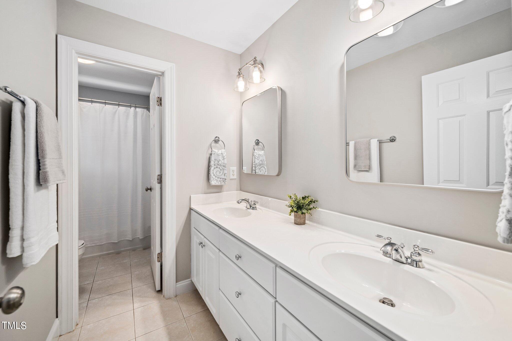 109 Chilcott Lane Apex, NC 27502 - Photo 25 of 34 a bathroom with a double vanity sink mirror and double