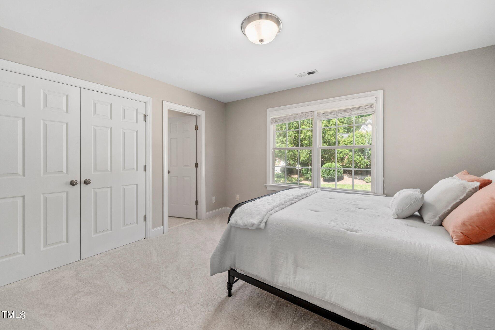 109 Chilcott Lane Apex, NC 27502 - Photo 26 of 34 a bedroom with a bed and a window