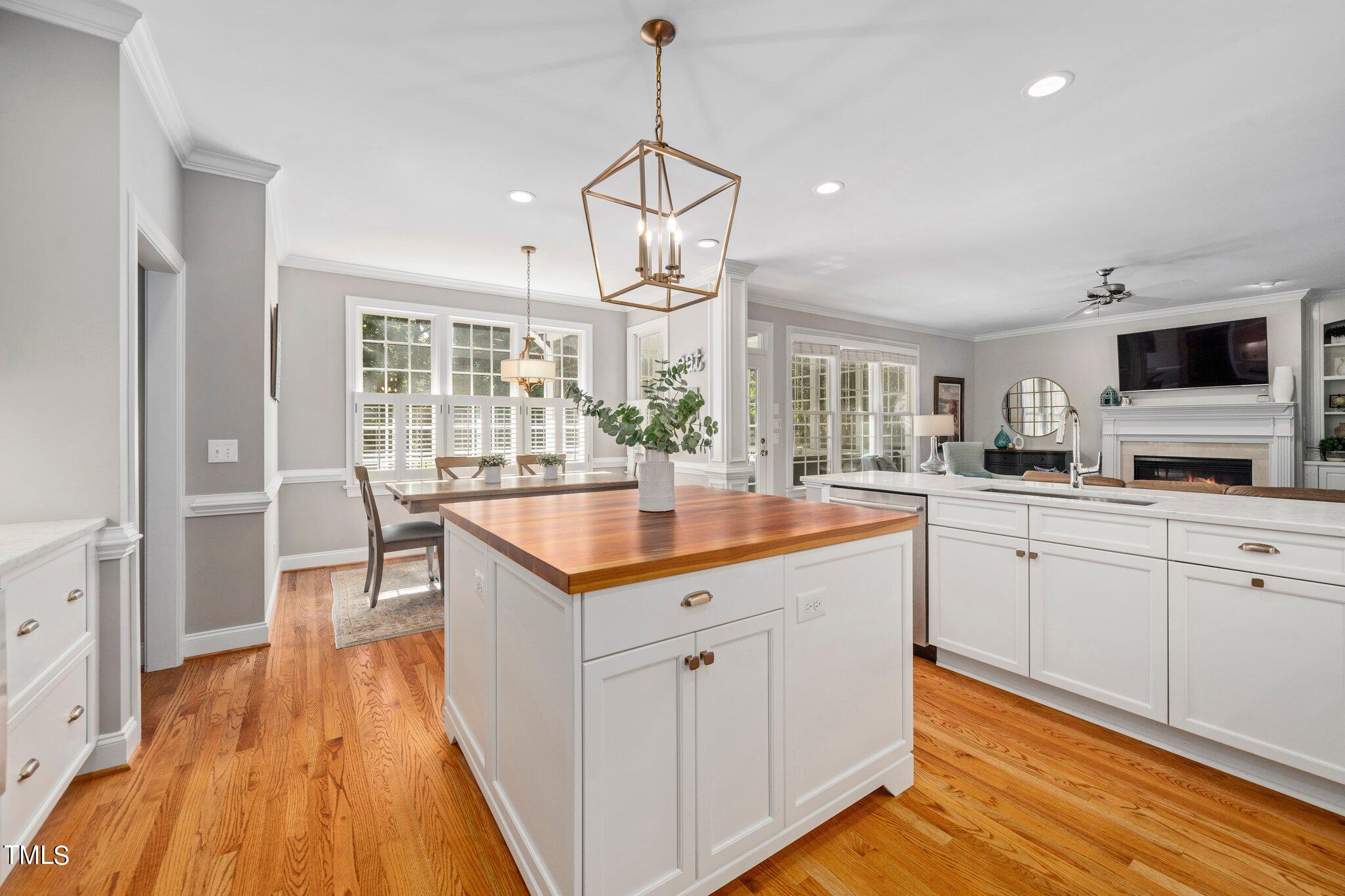 109 Chilcott Lane Apex, NC 27502 - Photo 6 of 34 a kitchen with granite countertop a sink cabinets and wooden floor