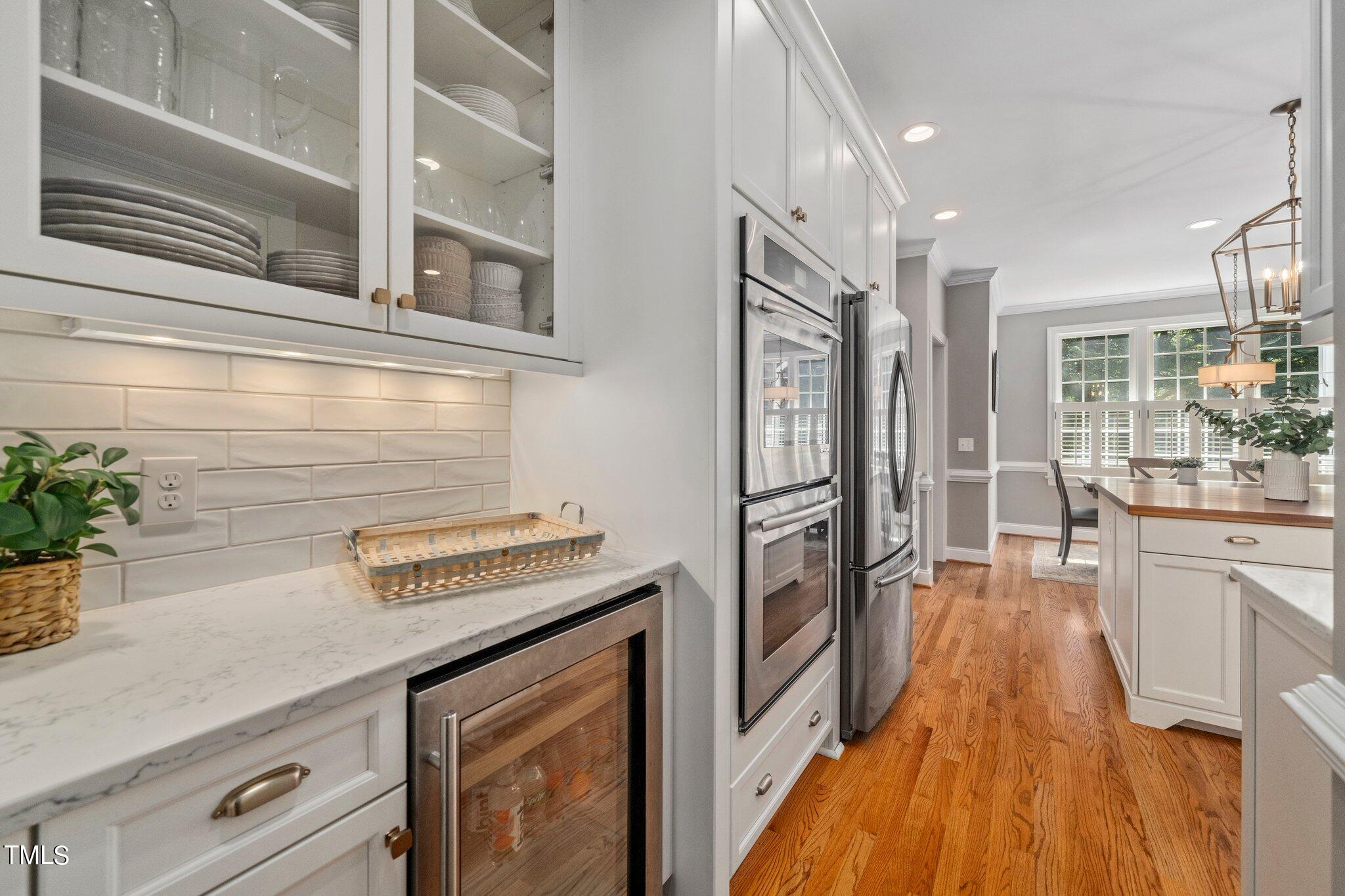 109 Chilcott Lane Apex, NC 27502 - Photo 8 of 34 a kitchen with cabinets and wooden floor
